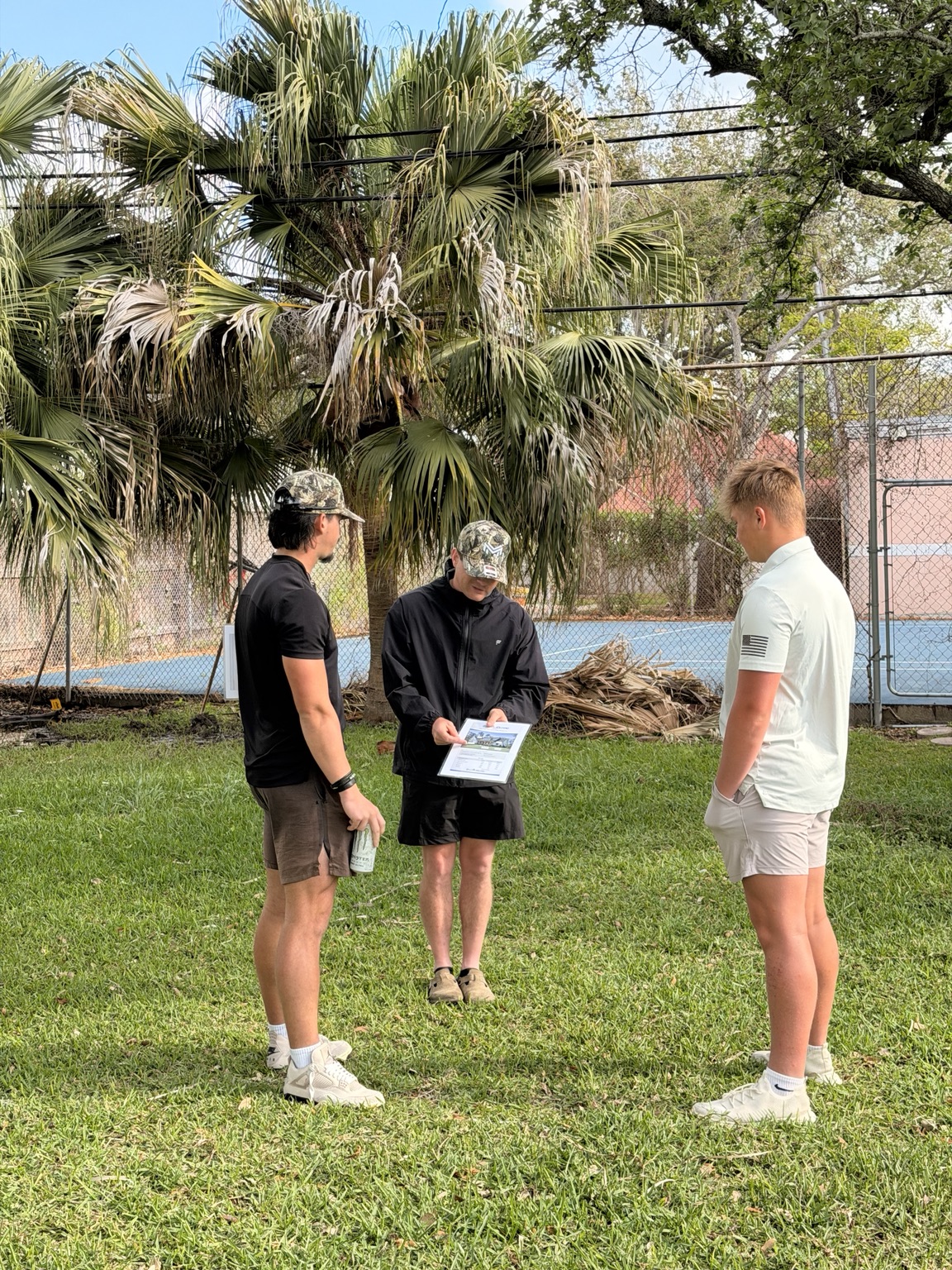 Three Rally reps reviewing a sales presentation sheet together
