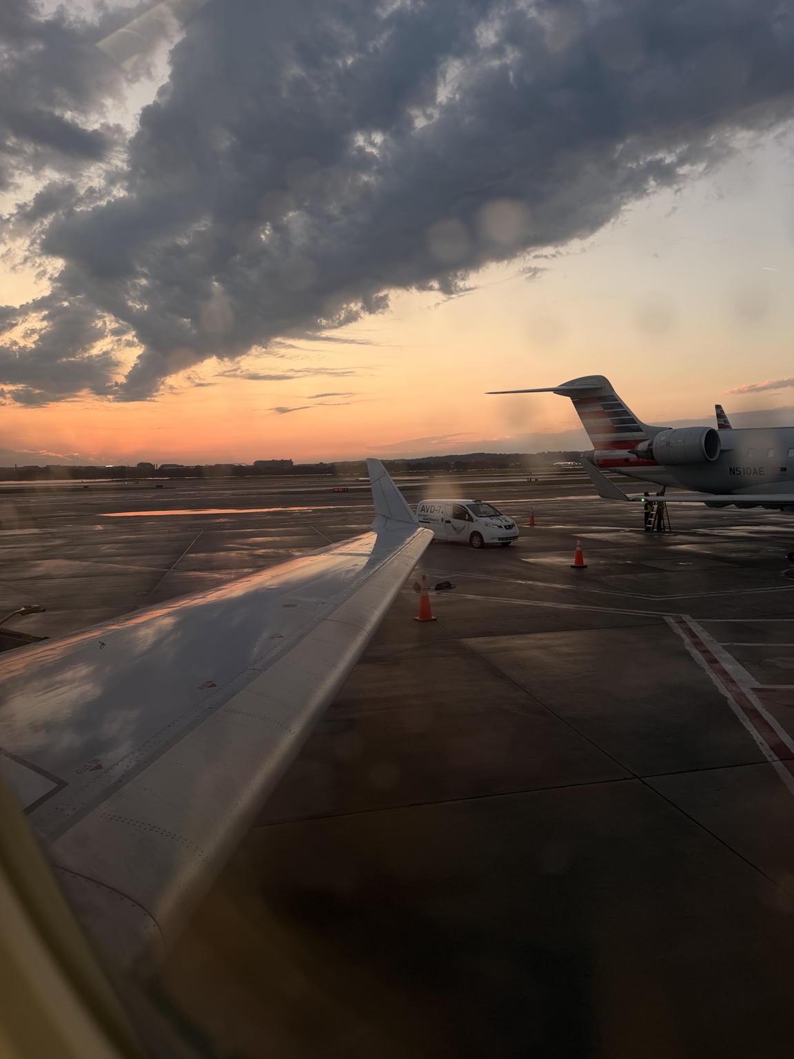 Airplane wing on the runway at sunset