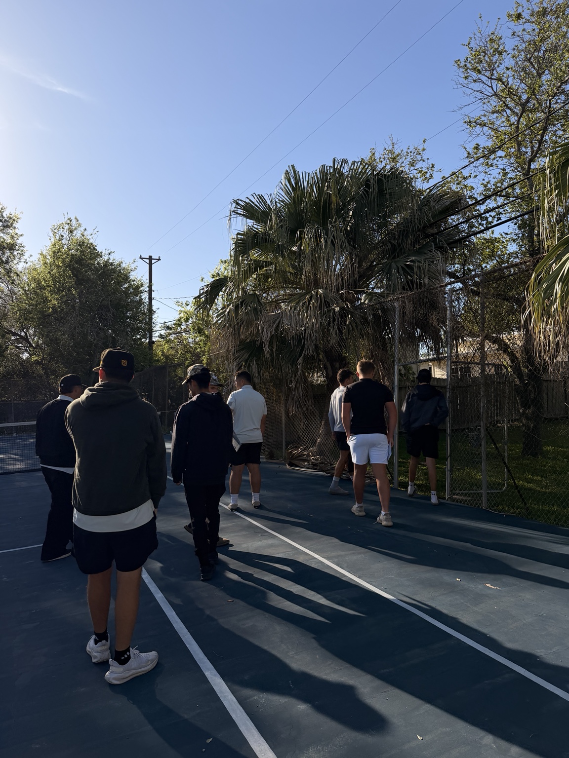 Rally reps practicing outdoors together on a court